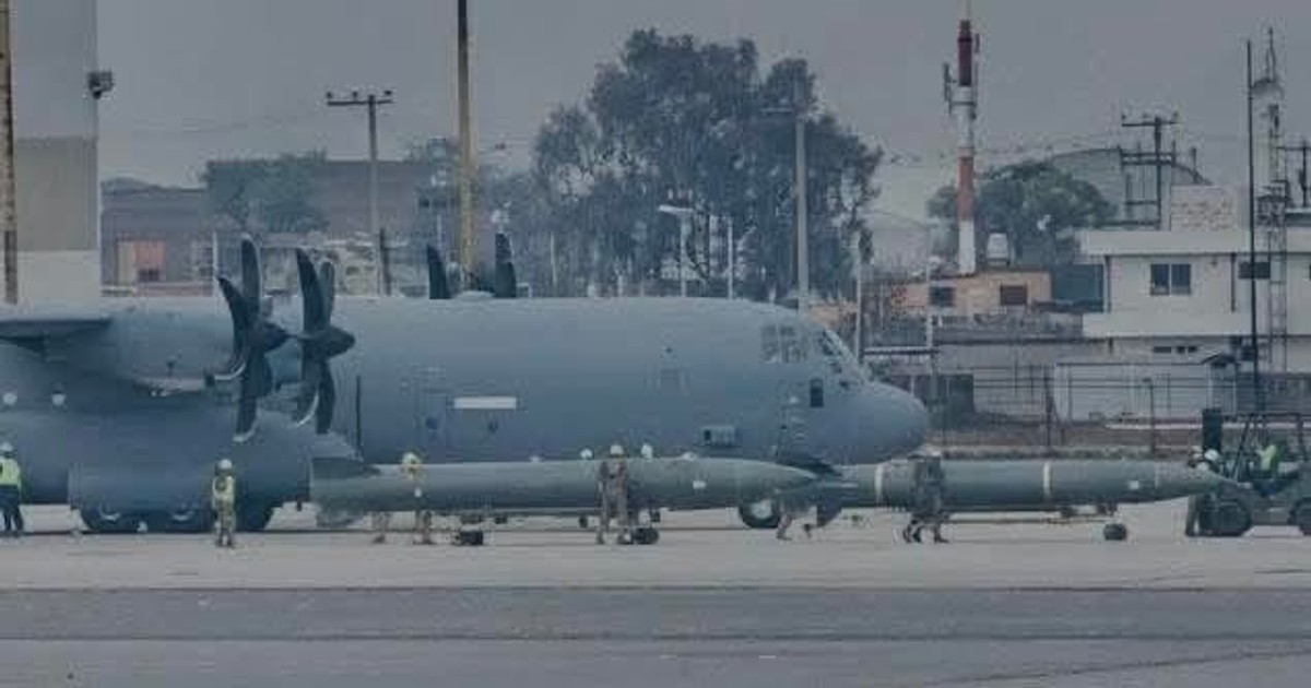 Avión militar estadounidense C-130J Super Hercules estacionado en el Aeropuerto Internacional de Toluca, rodeado de personal y misiles en el suelo.