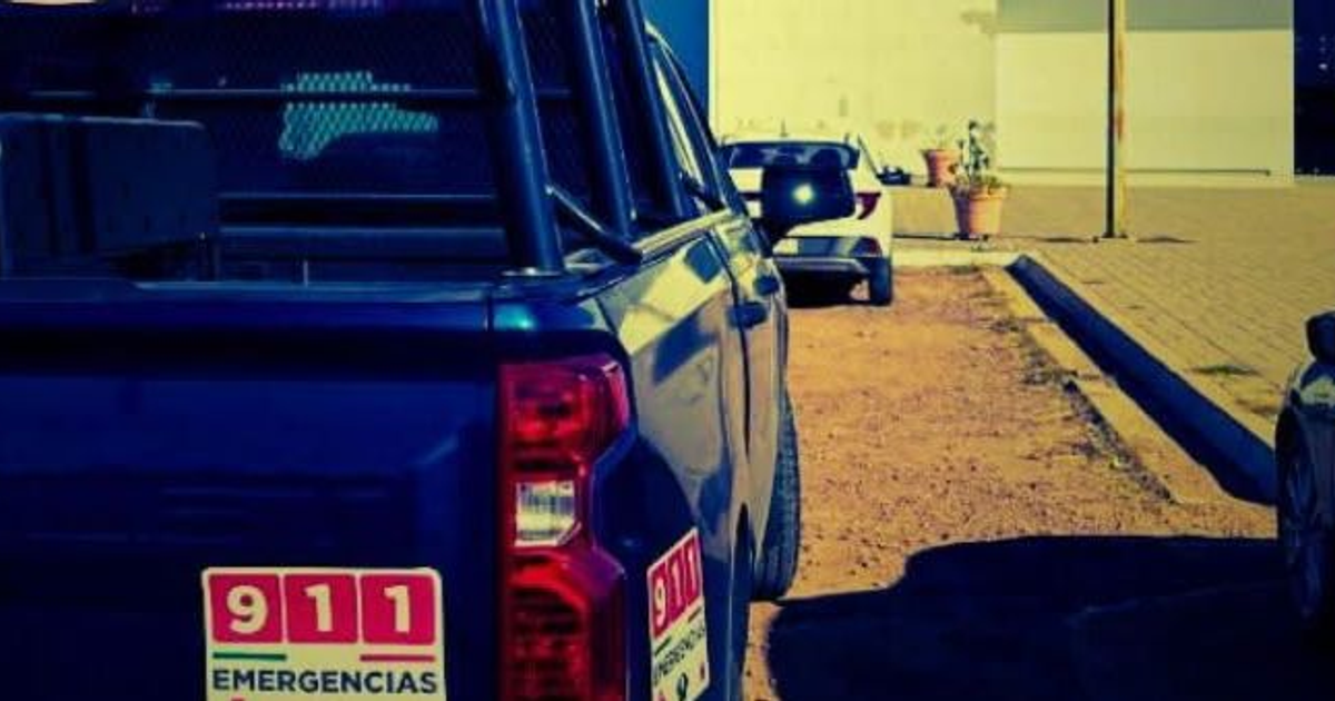 Vehículo de emergencia azul en estacionamiento, relacionado con caso de homicidio en Sinaloa.