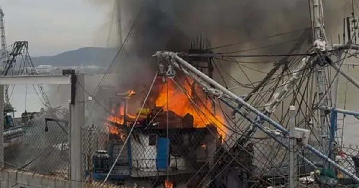 Barco incendiándose en el puerto de Mazatlán, emanando humo negro