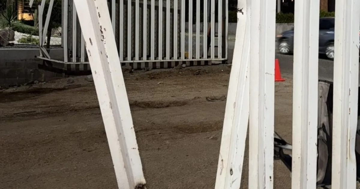 Vehículo cerca de cerca blanca en área de construcción