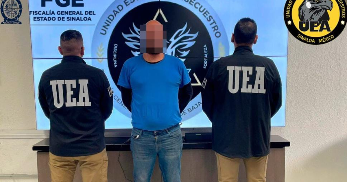Agentes de la Unidad Especializada Antisecuestros escoltan a detenido en centro policial.