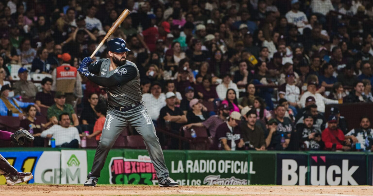Jugador de béisbol en uniforme oscuro a punto de batear durante las semifinales de LMP en Kuroda Park